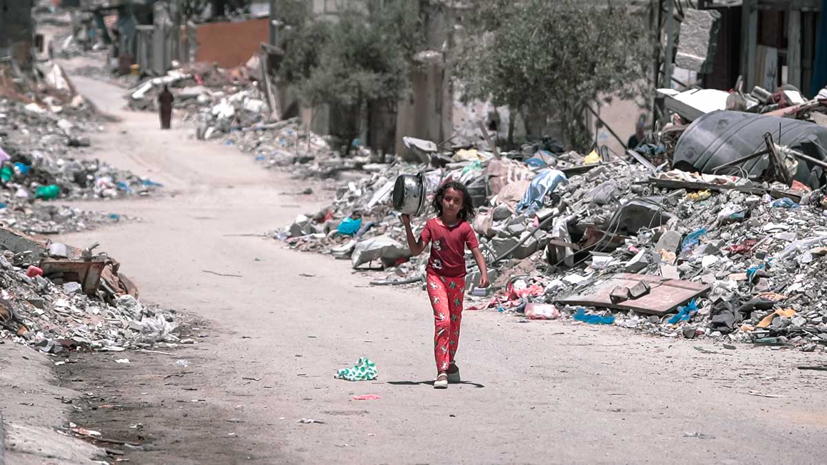 A girl walks inside Gaza during the Gaza Israel war to get food